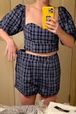 So disappointed in the fit of this top. There is no shape to the bust, so it flattens the chest and then there was many inches of extra loose fabric below the bust. It had SO much potential for being adorable.
Would only recommend for smaller chested babes, and even then size down at least one size. The pictures below only show a little on the top as I was focusing on the sizing of the matching shorts, but you can see the way it sticks out below the bust on both sides without me pulling the top to show how much extra there truly was... - Tonya H.