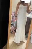 It fits great! I needed a few inches off the length since I'm so petite and a little bit taken off of the straps. Once I got it altered I cried because I loved the way it looked! I recommend this dress if you are wanting something simple but elegant! - Brianna G.