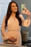 Absolutely loved this dress and I got so many compliments! I wore it for my gender reveal. 
I looked at reviews before ordering so I sized down to XXS and it fit great! 
I was worried sizing down it wouldn't fit in my arms or the length would be too short, but it was perfect! I even wore heels and it was still long enough! The quality is outstanding! Definitely recommend! - Kourtnie B.