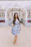 I ordered this dress in a L and XL because I was between sizes. The waist does not stretch and the L was a bit tighter in the bust. So I went with XL for comfort. However, could have worn the large with a bra that provided more compression. The sleeves are quite long, but I was able to bunch them up my arms. It is perfect for a gal on the shorter side as the hem is on the shorter side. It was perfect for my doctorate graduation pictures. Not too revealing and wonderfully flowy. - Christina Y.