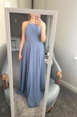I love it! Bought for a friends wedding coming up in July. The back straps are adjustable making it sit how you would like. The dress is long, but that's to be expected as it has to fit a wide variety of heights! I will be getting mine altered to take off a few inches, which I planned on doing before buying. The price and quality are great. It's not see through, and it's very flowy which is super fun. Keep in mind you have to wear sticky boobs or go braless. (Worth it!) - Nicole H.