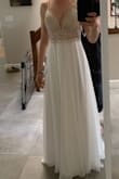 I bought this dress a little big because my wedding is in August and I don't want anything too tight. I normally wear a 6, but this 8 is exactly what I wanted. The beading is spectacular. The bottom is flowy and romantic. It's perfect! - Karolina K.