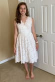 The skirt is more poofy in person than I thought it would be. The dress also doesn't look white - the nude underneath and the actual lace material make for more of an ivory/off-white color. - Marie D.