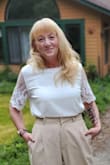 After getting this I decided to order all of my tops in small, the medium runs a bit large and is a little bulky when tucking it in. Other than that is is a gorgeous, light blouse, that will go with many outfits. - Sabine C.
