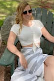 Feels shorter on me than it looks on the model. But still cute. I like to wear high waisted things with it. I tie the knot tighter so you don't see the hole. My skirt is also from lulus and I love it too - Elizabeth L.
