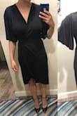 I usually am a true medium in Lulus, but I sized down based on reading the other reviews. I recommend sizing down! I am pretty busty so I usually can't size down unless the fabric is stretchy. This one is stretchy! The lining goes almost down to my knees and the cross over is flattering. I could probably have sized down again if I didn't need the lining as low, but this is for a funeral so I will stick with the longer length. Only reason for not putting 5 stars is that I think the cut could be a little more flattering, but I am still happy to keep this and if they sold other colors I would still get those too - Jess F.