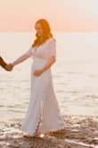 Purchased a size up due to being pregnant, and the medium was loose with lots of space for wear. I can definitely keep wearing this throughout pregnancy and after as well! It's lined and lightweight. Highly recommend - Jenna F.