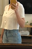 I read some reviews that said to size down, but I wish I had gotten my usual size M. I went with the small and it's a little too cropped and too fitted. I think this shirt is supposed to have a relaxed fit. When I lift my arms, the shirt gets stuck on my chest and doesn't fall back down without adjusting- the shirt also goes well above my belly button when I lift my arms. Holding out for a restock of sizes. - Holly K.