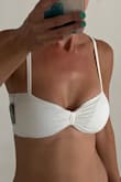Really liked the style of this top, but the padding shows too much and when you remove the padding, it is transparent.  I also feel like it may have been too small for me. I'm 32DD but usually get a small in these types of tops so they don't fall over, but maybe a medium would have been better.  Either way, they sold out of the matching bottom so will have to return. - Lynette B.