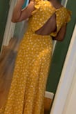 This dress is very pretty. Beautiful color. I wear a size small. The back was loose. I couldn't figure out how it fit perfectly everywhere except in the back. The sides were open and flappy. I was not going to spend money to fix it after spending so much to buy it. So I ended up returning it. - Thresha P.