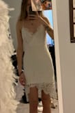 I wore this dress for my graduation photos. It is so cute and fun! I am 5'10 and ordered a small. It was a little short on me (obviously) but surprisingly a little baggy around the waist/hips area. First pic is when I first tried it on. I wanted it to be a little more form fitting, so I ended up getting it tailored (second photo). The lace is so beautiful. Like others have said, the neckline/front area is a little loose so you might have to end up pinning it if you want it to be more closed. Overall very cute dress; if you're tall make sure to wear spandex underneath or consider ordering a size up. - Emma P.