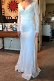 The front of this gown is simple and elegant. The v-neck is a great style for someone like me with a small chest. I can't decided if I look the back. The "wings" are unique! The dress accentuates the rear because of the cut out beneath it. There is no train, sadly, but the length is perfect for someone my height. The lace doesn't look cheap and the long-sleeves is really beautiful. - Elaina C.