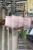 The material is flowy, moves, but it does wrinkle easily. It fits me perfectly with the medium; however, I think I would order my normal size large for more room to grow if my booty gets bigger, which I am in the gym to get fit, so it might just. It is a beautiful dress, and I received compliments on it all night and would repurchase it. I wore it to a wedding and will be wearing it to my girl's brunch date, and I am excited for all the asks of where you got that from. I sized down from the reviews but I think the large would have been perfect for me. - Shantia R.