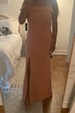 I actually love this dress! It runs pretty true to size/slightly bigger which is nice to have the extra breathing room. The slit makes it super flirty and the off the shoulder is stretchy so you don't feel stuck in the dress. Definitely recommend this!! - Cristina D.