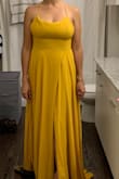 The material is very nice and flowy, but this dress is for someone with a TRUE cup C and tall!  I'm a 34D (32DD conversion). I had ordered two size small on other style dresses and neither one fit the bust. Then I ordered this one in a medium and it was too big from the waist and too small from the bust. Also the slit is ALL the way to the top, so if you know you'll be in a windy situation or know you'll have to sit, you'll have to hold the material to avoid showing your underwear. Very long, I tried it on with high heels and it was still dragging to the ground. - Lorena A.