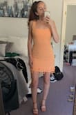 THIS dress, is so fun & flattering! The material is more so a light linen, doesn't seem like it would crease as easily as a thicker linen material. I bought this to wear for a summer vacation and bridal shower and I have received compliments on both the style and fit. The small fits great, there is still wiggle room, a medium would not have formed right with my curves/hips. SHOES are also Lulus...highly recommend those as well! - Jenna G.