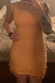 I absolutely LOVE this dress! I purchased it for a summer wedding and vacation dress and it can definitely be dressed up or down with shoes/jewelry. I typically wear a medium and I'm glad I stuck with that size. It is snug but not to the point that I feel like I'm popping out of it. The fabric is not stretchy, and is very light and comfortable. For length, it comes down a little past mid-thigh - Danielle E.