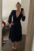 This dress is excellent quality and very pretty. It's heavier material and would make a great holiday dress. Also,  the V is super low on me, much lower than it appears on the model. I would need to tape my bust up and to the sides so just my sternum bone is showing and not a ton of cleavage. I bought it for an outdoor summer wedding and it's too wintery in person. It's a bit darker in color than the model photo - in natural lighting it's much more navy/black in appearance. I'd definitely keep it, but it will sit in my closet for too long until the right occasion. Gotta Marie Kondo my life! - Kristin M.