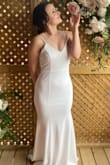 I bought and wore this dress for my intimate wedding. I was a little nervous to buy a size small knowing I was in between sizes at the time. I'm so happy that I did - the material is super stretchy and comfortable that it hugs in all the right places. I'm not very "blessed" up top but with the right sticky bra, it was very flattering! Everyone commented on how gorgeous the back was especially with the peek-a-boo lace at the bottom. It was also so comfortable that I didn't even end up changing into my second outfit! - Jenn P.