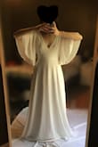 I love this dress, it drapes beautifully, and the flutter sleeves made me feel angelic. Great quality, especially for the price. XS fit me perfectly (with the exception of length, but I'm short). The dress is a bit heavy, so it might feel hot in the summer. I nearly picked this as my wedding dress! I just decided I would rather have a lacy dress instead. - Kristina H.