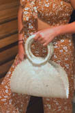 It's not as functional as it is cute. I wore it on a beach vacation with friends in Florida. The bag itself is adorable but flimsy. As soon as you set it down all your things inside fall out due to the lack of structure. I will still use this bag, just wish it was more sturdy. - Hailey M.
