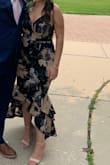 Fits true to size! A little long for me but I wore higher heels so it worked out okay. Perfect dress for a summer wedding! - Xochil R.