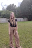 These pants are flowy, but not too baggy. They look great on and the color is perfect! They are really long, which I normally never have an issue with. However, it's not so long that you step on the bottom of the pants, especially with shoes. Would be great paired with heels! - Hannah L.