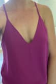 It's a pretty color, flattering fit and a rayon type material that doesn't wrinkle. Long enough to tuck in. Wear adhesive cups and good to go! - Rosalee M.