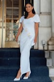 I am a petite person. 5'1. The dress is stunning and I wore it for my bridal shower. However, I had to pay extra to cut 4 inches off the bottom to make it a suitable length for me. It's made for tall people. A petite size would be great. The overall fit was perfect for my body but the length was super long. Overall satisfied with the dress & if you don't mind altering to fit your height, I recommend it. - Fahima Y.