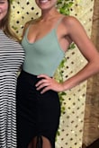 Love the color. It has a nice stretchy material that doesn't wrinkle easily. The bust area fit super well, but I have a pretty small chest. The only downside for me personally was that the button area on the bottom is uncomfortable when you first put it on. Goes great with everything! - Jessica A.
