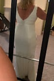 This dress is classic, simple, and elegant. The material is very soft, and the feathery tufts at the neckline did not even touch my skin. I ordered it with several others, and ultimately decided on a different dress, but this was a very close second. Exactly true to size (I'm a 12-14 in street clothes). Looks like it would be very easy to hem to desired length, and it is long enough to wear with sky-high heels if you wanted to. - Amber R.