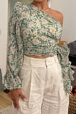 Top is as pictured and very cute. It unzips on the side so it's easy to get on, but it was very tight on me when zipped and there's no stretch. Can't eat a lot in it lol but sizing up would lose the shape which keeps the top flattering with the poofy sleeve. - Amara L.