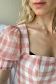The fit was good, and maybe this is just the one I got, but the bust line was cut too wide so that you could see the top cups of my bra on the sides. I wore a dark bra in the picture so you can see. Also a smaller note: in the photos of other reviewers and the model it looks like more of a sweetheart neckline but the one I got was straight across. Also sorry I don't know why but the one photo kept uploading rotated the wrong way, but you get the jist. - Michelle T.