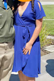 Needed a dress that is modest yet still cute. Color shown on stock photos looks darker but after looking at prior reviews and photos, color was exactly what I wanted. Front had a large opening, I wore a nude cami underneath and still looked okay. Love the wrap style. - Amanda L.