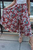 I love this skirt. Following reviews here, I went with the XS, since I'm short and the waist is elastic. It fits great and stays up without feeling constricted. The fabric is so light, and flows when you walk if there's any breeze-- felt so epic going down the stairs! The slits make it even more airy and fun, and they don't go too high so you can definitely wear bike shorts or shapewear under. This skirt looks and feels great on, can't recommend enough! - Monica A.