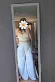 This suit is really cute. I got it for my bridal shower; I never wear white, so I was nervous, but this is so flattering and cool while still being super wearable and comfy. My only complaint is that the pants are crazy long. I'm wearing 4" heels in the photo and they're still too long, so I'm planning to hem them. The top fits pretty well; I love that the tie back makes it adjustable. My 34F bust never fits in tiny crop tops, but this lets out enough space up top to fit me without looking trashy. If you have a smaller chest, you can tighten it to fit and I think it would still look great! Overall, a great outfit! - Lindsay S.