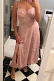 I'm a petite girl and went by the size guide and ordered a small. I wish I can exchange for an XS but they're sold out. It's pretty loose, especially around the waist and bust area. This is closer to like ankle length for me being only 5 feet tall lol. There's some stretch on the back because of the smocking which is why I wish I got an XS instead! - Jessica S.