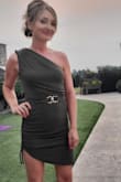 The material is stretchy and soft. I added a belt to dress it up for a night out. The color is stunning. I did cut the strings on the side of the dress...I just didn't like how long it hung down my leg. Lol - Shannon R.