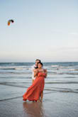 The dress was a tad long, but I didn't get it altered because I love the way it looked when the wind caught it and I specifically selected this dress for beach photos. If you are busty, finding a good bra that doesn't show under this dress is pretty difficult. I tried boob tape, it didn't work for me, but could work for others. Overall, I loved this dress and the color looked great against the ocean. - Alyssa K.