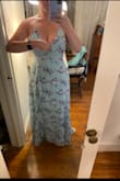 In no world is this dress green. It is most certainly a light blue, with maybe a touch of mint. The flowers also appear darker and more in contrast with the background color in person. 
However, it is a beautiful blue dress, and the cut of the layers is very flattering! No I returned it, I did feel very pretty in it and loved the adjustable straps and lace-up back. In photos, I have it held where I would have gotten the bust area tacked up for more coverage. Highly recommend if you're looking for a blue, flowy dress! - Cami R.