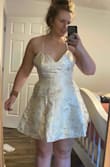 This is one of the weirdest fitting dresses I've ever put on. The fabric is stiff, which isn't really a huge issue, except for the fact that it means you'd have to have pretty specific body dimensions for it to fit right. I want to say it runs big but I don't really think sizing down on this would help me at all. The chest comes nowhere near to fitting, and the pockets stick out in a weird way. The pattern is so so beautiful, and I've been so happy with my past Lulus orders, so this was disappointing. - Jordan H.