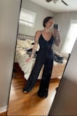 I love love this but a heads up the straps aren't adjustable and the material if the straps/top stretches which could leave room for some *slips* I am going to have the straps altered and pants hemmed (they're a tad long But I'm also short) overall it is gorg! Love the double-slit! - Katie R.