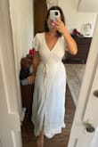 I'm between 5'3 and 5'4 and Lulus maxi dresses are always way too long on me! I think it would have been okay in heels but that wasn't the issue here, the dress fit basically everywhere except my chest, which was too small. And it's too small ONLY because there's a little snap enclosure to create the V-neck and it's placed very awkwardly and made the dress pull right at my boobs. With the snap undone the top of the dress was super loose so it's not like the dress itself was too small. Maybe if I had the time and patience I could have taken it to a seamstress to place the snap enclosure lower down or something, but I just returned it. Also I wasn't a super huge fan of how the material overlapped at the waist and showed through. This probably is only an issue on the white because it's a little sheer (my fiancé told me he could see my blue underwear from the back, so just a heads up there). - Hannah S.