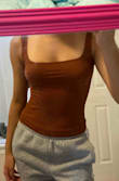 My main concern was that this top would be too small. After ordering, I became worried by all the reviews saying that it runs small. There were women with smaller measurements than me saying that it was overly tight. When it arrived and I tried it on, I found that it wasn't too small or tight at all. I'm glad I didn't size up. It fits perfectly, with lots of stretches leftover. Could definitely fit a size small. Another thing is the fabric. Lots of reviewers described the material as being too thin, but it was actually thicker than I expected. Very soft, I could see myself sleeping in it if I wanted to. Excellent quality and not see-through in the least. - Tiffany G.