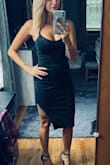 This is definitely a fitted dress, however the material is thick enough (but breathable) to hide any areas you might want. Fits true to size ,  yet if you feel more comfortable going up a size you probably can with it fitting close to the same. - Melissa Z.