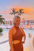 I ordered a medium as suggested by the size chart. It fit me great! I think a small would have also been fine but a bit shorter. The length is just past knee and the cut outs are very sexy without being too much. I got it fir our vacation to Cabo and loved how easy it is to dress up with heels or down with sandals. The knit was a bit toasty in the humidity of August but still comfortable enough. I love the rust color! It's perfect without looking too dressy. - Kate M.