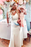 I wore this to my bridal tea party shower. It was amazing it fit so good. Definitely a show stopper. Back is low but not to low for a power short. Material is thick. Straps good length. I wore 5 inch heels and I'm 5'3 and a half and the dress touched the floor in the front. It has the lace train which obviously drags but you could alter if needed I like trains though. Oh I added a bridal belt from Lulus to accent the waist. I really didn't need it once I saw how the dress fit  but bought it with the dress and it was super pretty! - Katy A.