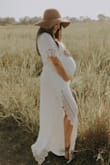 Beautiful high quality dress! This works as a maternity dress because the band is right below your bust! I am 5'0", 110lbs pre-pregnancy and was 140 lbs at 31 weeks pregnant for my pictures. For Lulus, I am usually a small for the chest and a medium for bottom because I'm curvy. I usually order dresses in medium to fit my butt and then have to tailor the top lol. For this dress (while pregnant), I ordered medium and large just in case. The medium fit great and zipped up very comfortably. Since I am short and my chest is smaller, I simply used a safety pin to hold the excess fabric behind my neck to avoid excessive cleavage. Highly recommend!! - Scarlet S.