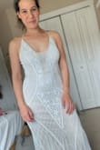 I love this dress! It fits beautifully. I have an athletic, curvy build and it's very flattering in all the right places. I did have to hem it, 4" off the tulle and I have 4" heels (with a 1/2" platform sole). - Lani T.