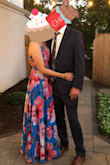 I wore this to my sisters outdoor wedding in August 2021. I got so many compliments from the hair and makeup crew to guests I didn't know. It's a very pretty dress and very flowy. It's light weight and easy to walk in but long in length (I'm 5'8 and wore 2inch heels and it was perfect - didn't need to hem). It is very forgiving as well, no need for Spanx or anything. I wore a strapless bra and it never showed. This dress wraps around you. I tied the waist ribbon secure (not too tight) and there was no slit. In the picture the model must be really extending her leg out on purpose bc it wraps around you fully. Really like this dress for summer events! - Vanessa B.